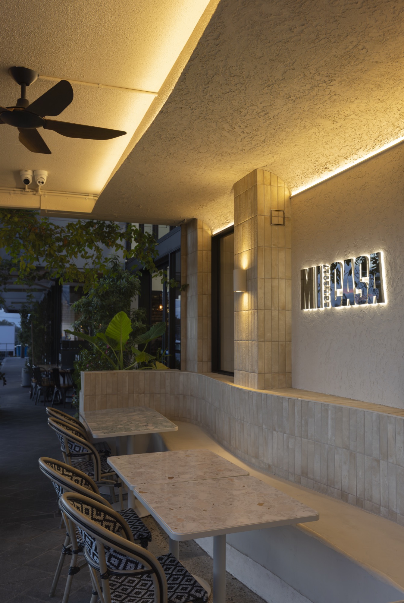Mi Casa outdoor seating with backlit MICASA signage
