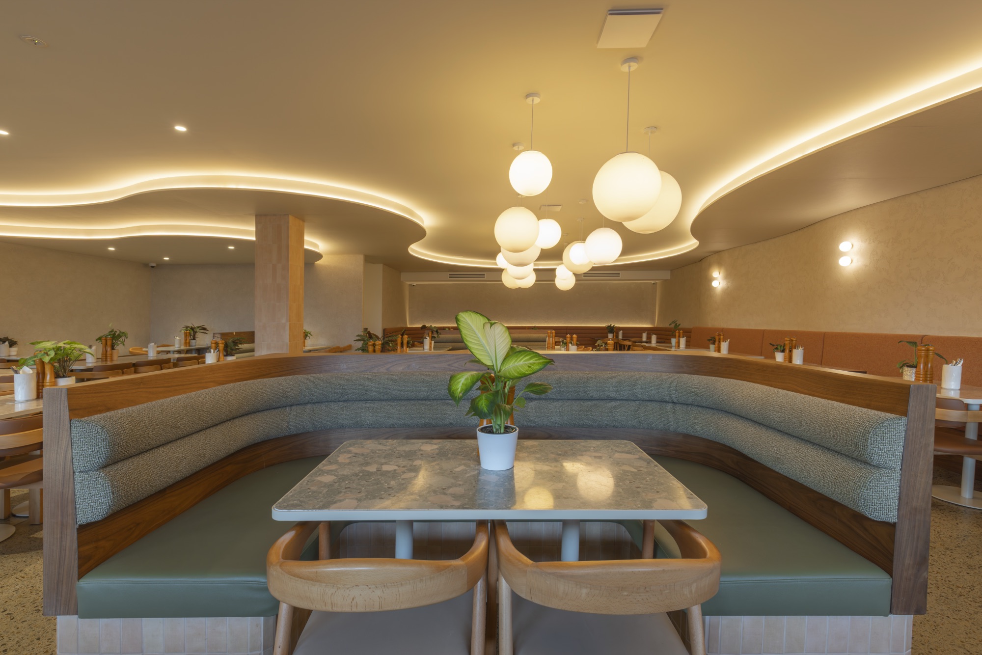 Booth seating beneath cluster pendant lights