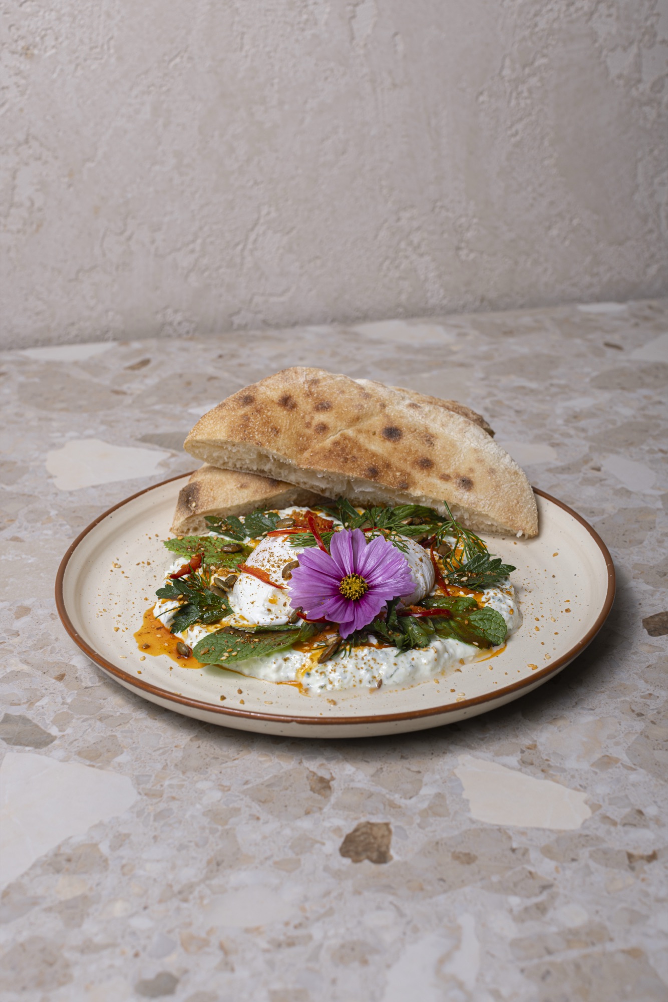 Turkish Eggs — poached eggs on whipped labneh with chili butter and herbs