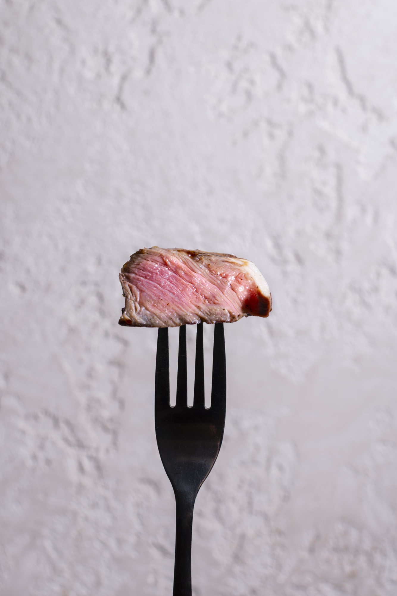 Sliced steak on a fork — editorial close-up